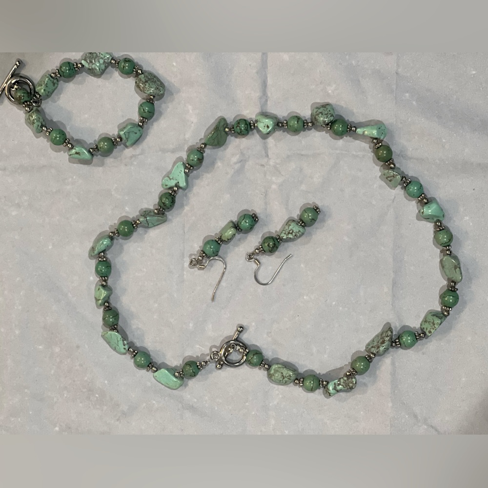Handcrafted green and silver colored beads and stones on filament chain